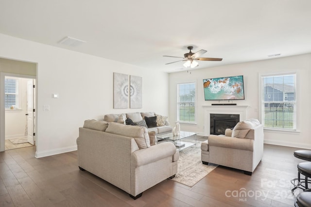 living room featuring ceiling fan and dark hardwood / wood-style floors