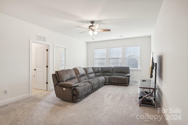 carpeted living room featuring ceiling fan