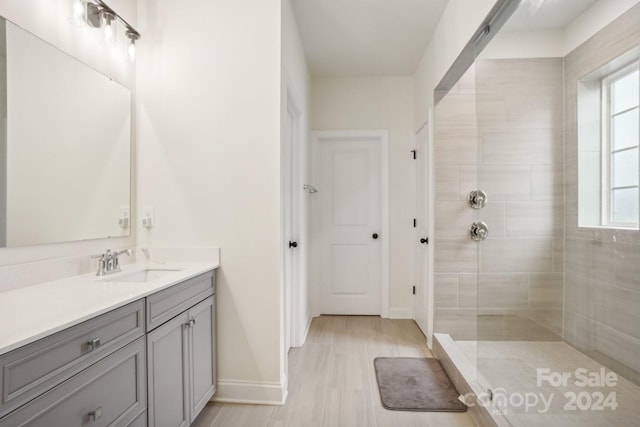 bathroom featuring vanity and tiled shower