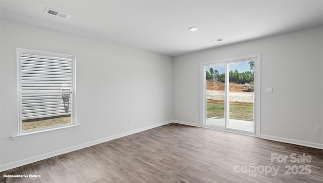 spare room featuring hardwood / wood-style floors