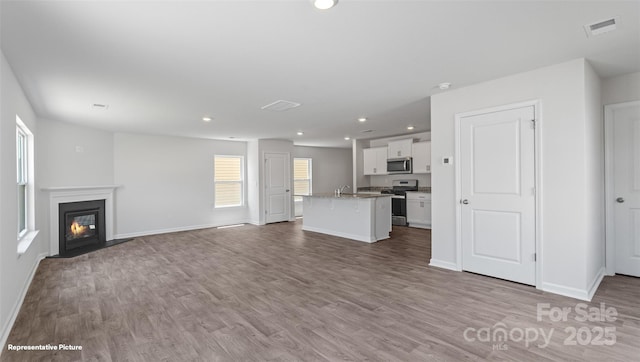 unfurnished living room with light wood-type flooring