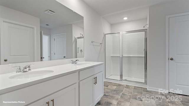 bathroom featuring vanity and an enclosed shower