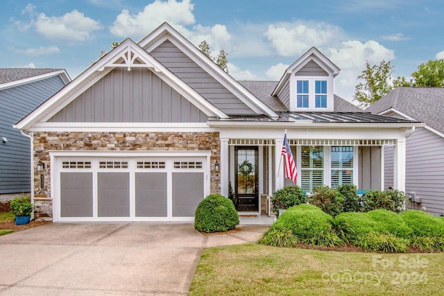 craftsman-style home featuring a garage and a front lawn