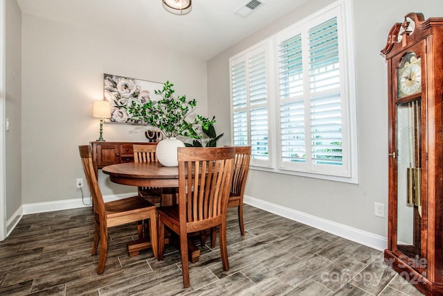 dining area featuring dark wood-type flooring