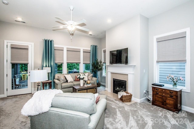 carpeted living room with ceiling fan