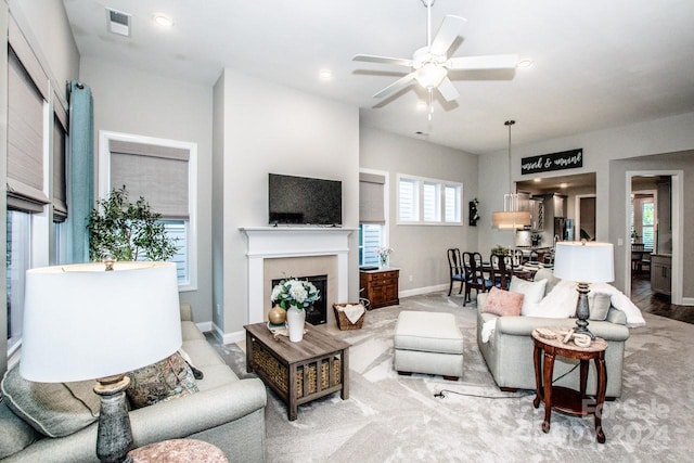 living room featuring ceiling fan, light hardwood / wood-style flooring, and a healthy amount of sunlight