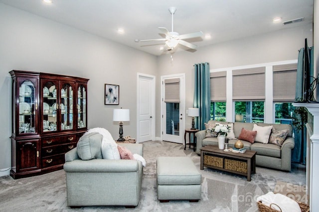 carpeted living room with ceiling fan