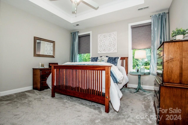 carpeted bedroom with ceiling fan, crown molding, and multiple windows