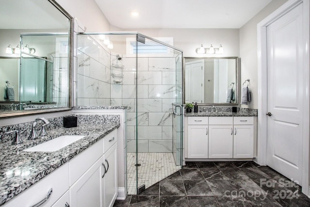 bathroom featuring vanity and a shower with shower door