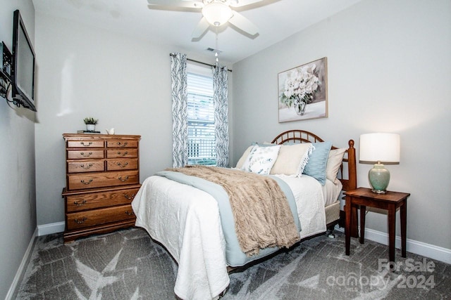 bedroom featuring ceiling fan and dark carpet