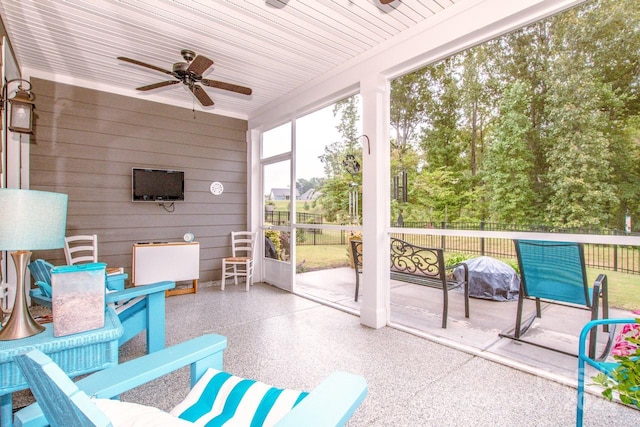 sunroom / solarium featuring ceiling fan and wood ceiling