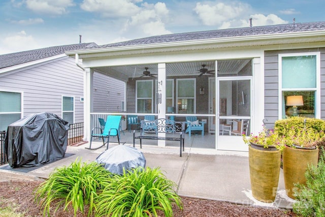 rear view of house with ceiling fan and a patio area