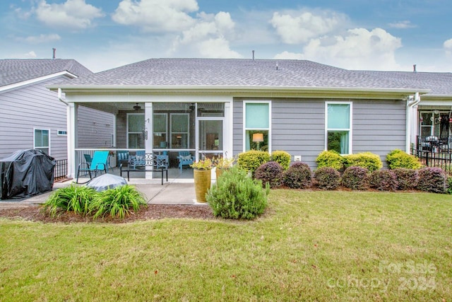 back of house featuring ceiling fan, a yard, and a patio