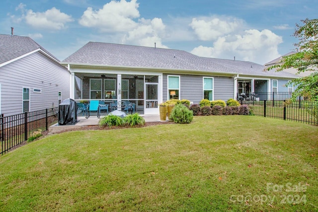 back of house featuring a yard, ceiling fan, and a patio area