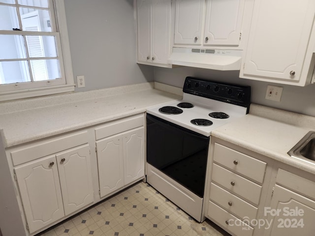 kitchen with white cabinets, white range with electric stovetop, and range hood