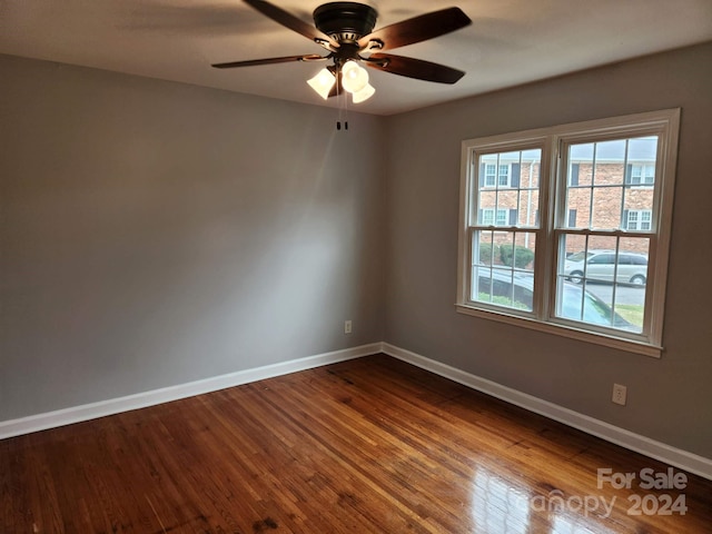 unfurnished room with ceiling fan and wood-type flooring