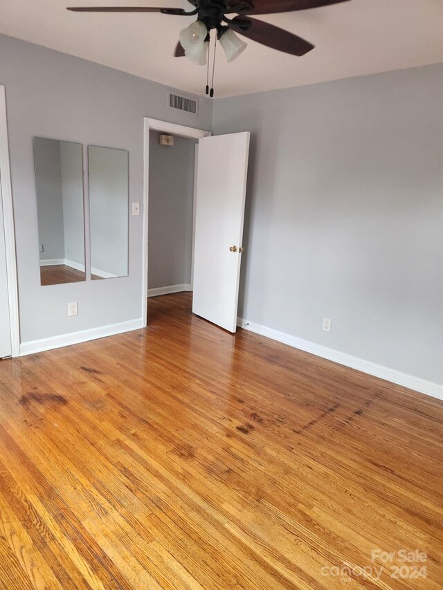 empty room with light hardwood / wood-style floors and ceiling fan