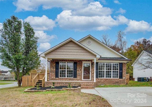 view of front of property with a front yard and cooling unit