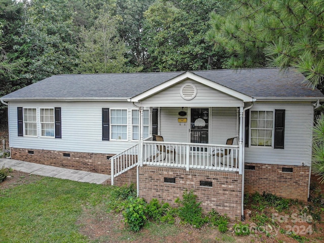 ranch-style home featuring a porch, roof with shingles, and crawl space