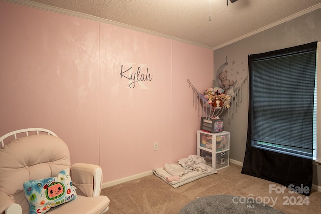 sitting room with a textured ceiling, carpet flooring, and ornamental molding