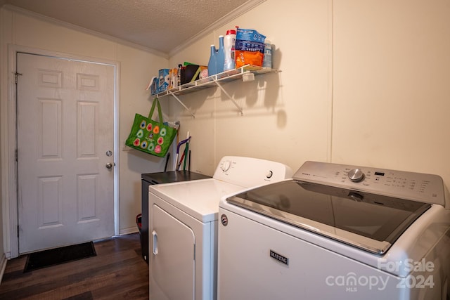 laundry area featuring crown molding, laundry area, dark wood-style floors, independent washer and dryer, and a textured ceiling