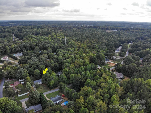 birds eye view of property with a view of trees