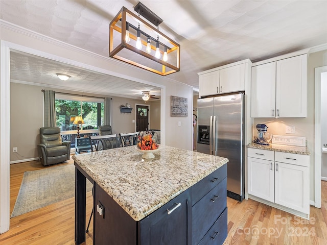 kitchen with white cabinetry, decorative light fixtures, light hardwood / wood-style floors, and stainless steel fridge with ice dispenser