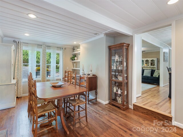 dining space featuring crown molding and hardwood / wood-style flooring