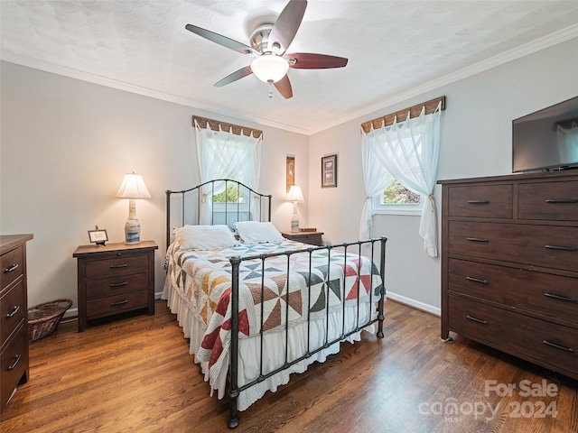 bedroom featuring ornamental molding, ceiling fan, and dark hardwood / wood-style floors