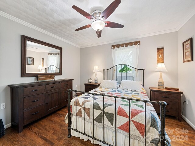 bedroom featuring ornamental molding, ceiling fan, and dark wood-type flooring