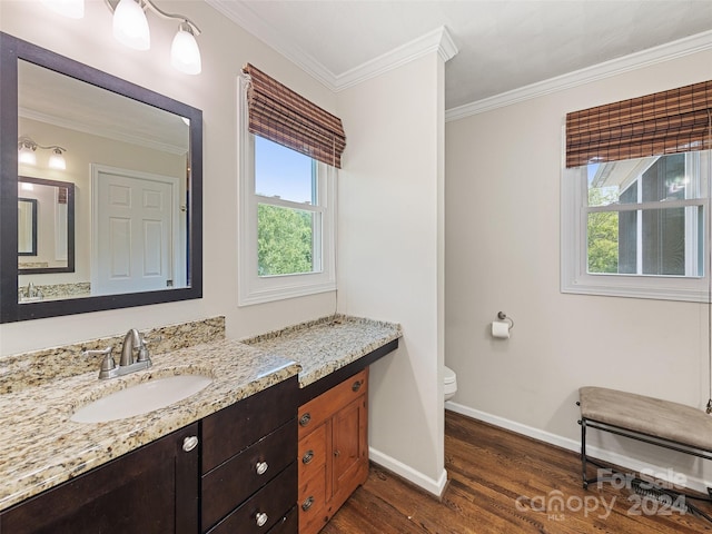 bathroom featuring crown molding, hardwood / wood-style flooring, vanity, and toilet