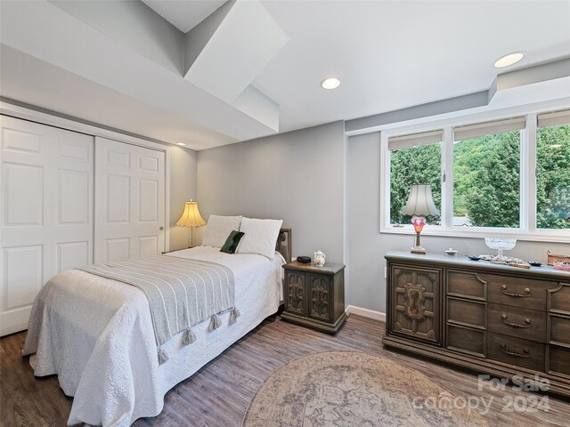 bedroom featuring hardwood / wood-style floors and a closet