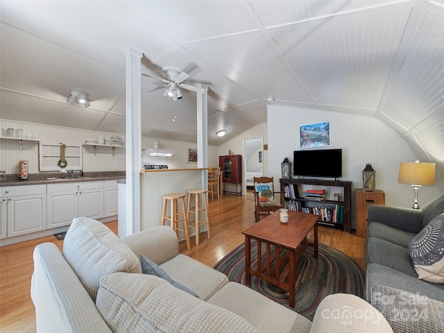 living room featuring lofted ceiling, ceiling fan, light hardwood / wood-style flooring, and sink