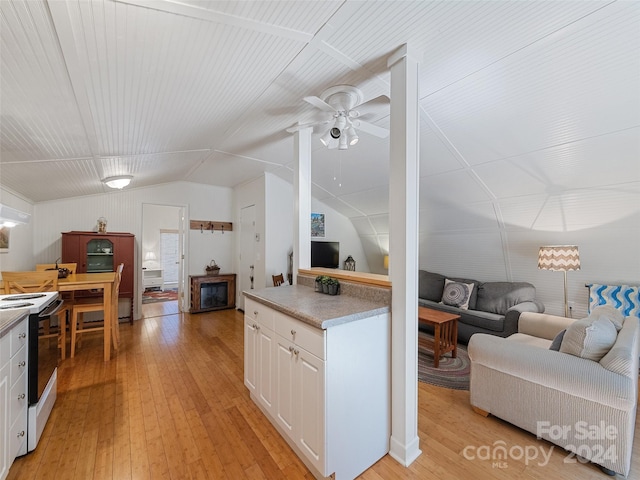 kitchen with white cabinets, light hardwood / wood-style floors, and white electric range