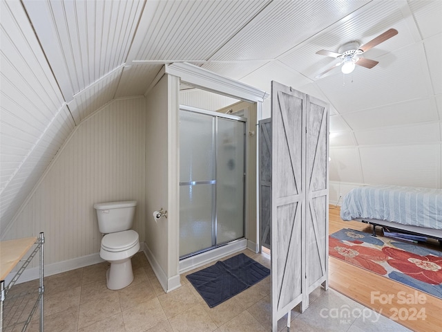 bathroom with walk in shower, wood-type flooring, vaulted ceiling, and toilet