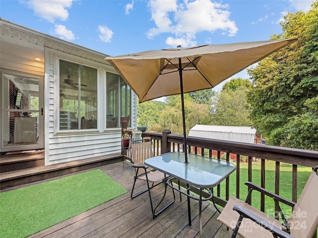 wooden deck featuring a yard