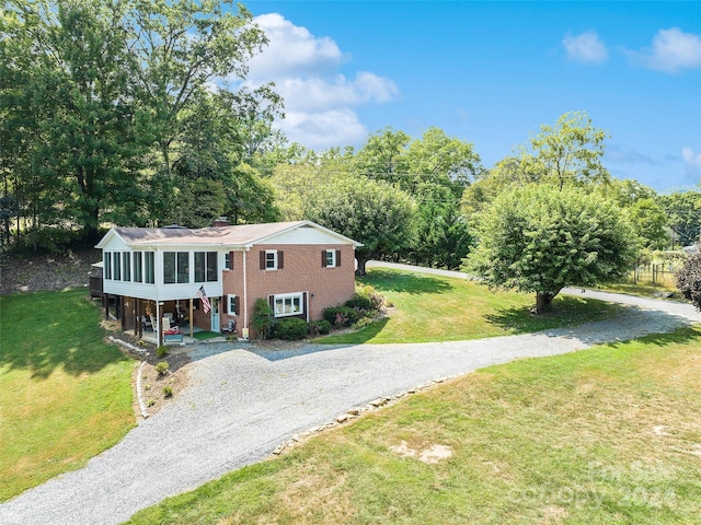 view of front of property with a front yard and a carport