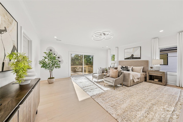 bedroom with access to exterior and light hardwood / wood-style flooring