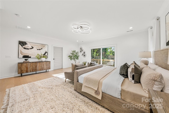 bedroom featuring access to outside and light hardwood / wood-style floors