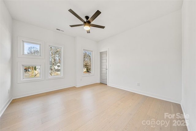 empty room featuring ceiling fan and light hardwood / wood-style flooring