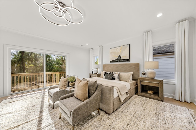 bedroom featuring access to exterior and light wood-type flooring