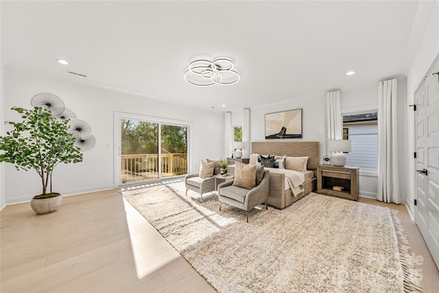 bedroom featuring access to exterior and light wood-type flooring