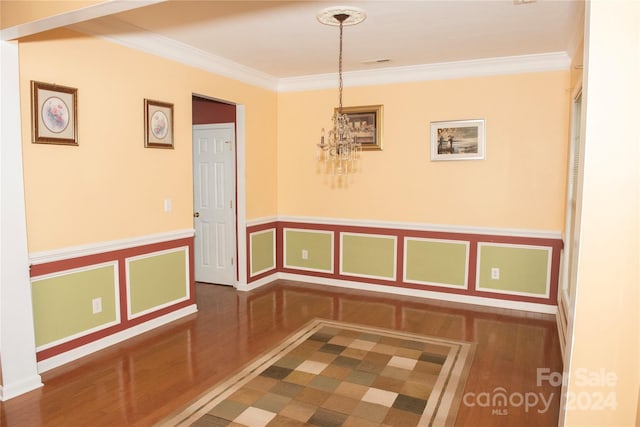 interior space with hardwood / wood-style flooring, ornamental molding, and a chandelier