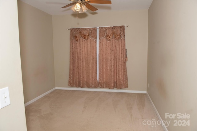 spare room featuring carpet and ceiling fan