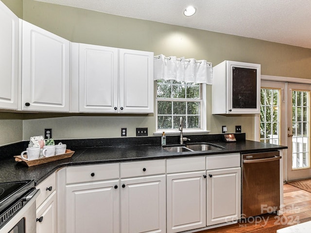 kitchen featuring sink, a textured ceiling, white cabinetry, dishwasher, and light hardwood / wood-style floors