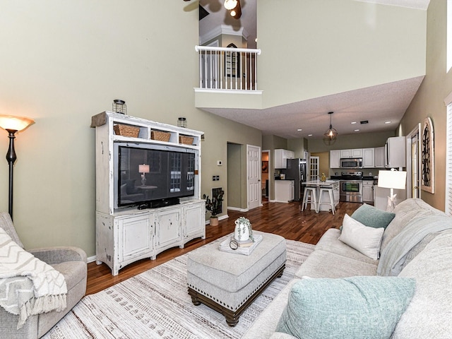 living room featuring light hardwood / wood-style floors and a towering ceiling