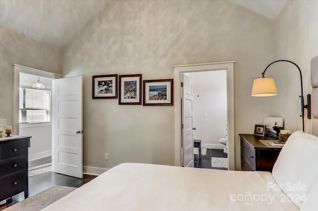 bedroom with connected bathroom, lofted ceiling, and dark hardwood / wood-style floors