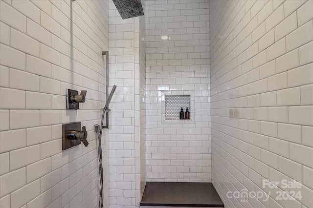 bathroom with tiled shower