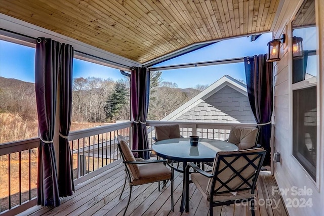 sunroom / solarium featuring vaulted ceiling and wood ceiling