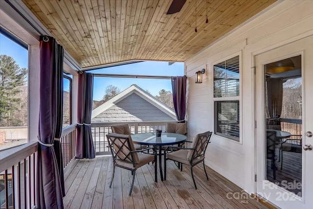 sunroom featuring wood ceiling, ceiling fan, lofted ceiling, and a wealth of natural light